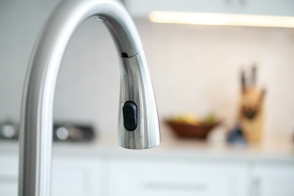 A clean brushed-steel pull-down kitchen faucet